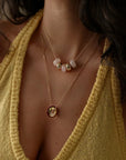 Ava gold rose quartz necklace layered with the Love Necklace on a v-neck sweater, MyAleph We Are One Collection