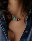 Noa silver charm necklace with turquoise quartz bead and diamond-detailed charms styled with a denim shirt by MyAleph