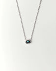Aura Evil Eye necklace featuring a turquoise gemstone set in a silver tone pendant with premium rhodium plated hardware on a delicate chain.