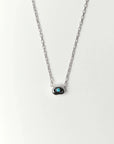 Aura Evil Eye necklace featuring a turquoise gemstone set in a silver tone pendant with premium rhodium plated hardware on a delicate chain.