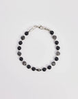 The David Bracelet in Silver laid flat, showcasing its polished silver finish, black onyx beads, and a single evil eye charm with a black CZ diamond.