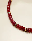 Close-up of the Lilou cherry quartz necklace, highlighting the rich red beads and gold accents that provide a luxurious and striking appearance.