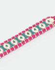 Close-up of MyAleph Riviera Bracelet with green and fuchsia cotton cord, glossy enamel evil eye details, and adjustable closure