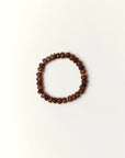 espresso quartz beaded bracelet with gold spacer details photographed in a full flat lay on a soft cream background
