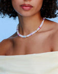 Model wearing the Valerie white quartz necklace, styled to highlight its elegant white beads and colorful dividers, adding a chic and sophisticated look.