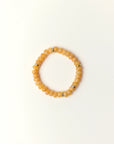 Zoe Tangerine quartz beaded bracelet with gold spacer details photographed in a full flat lay on a soft cream background