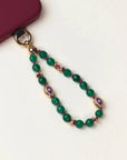 Green beaded phone chain with a red phone case on a white background
