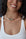 Terre gold choker necklace with garnet, turquoise, onyx and malachite stones on model