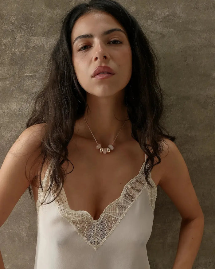 Ava gold necklace with rose quartz beads styled on a lace cami, MyAleph We Are One Collection