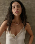 Ava gold necklace with rose quartz beads styled on a lace cami, MyAleph We Are One Collection