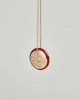 Love Necklace by MyAleph, gold disc charm with red enamel border and love script engraving, front detail view