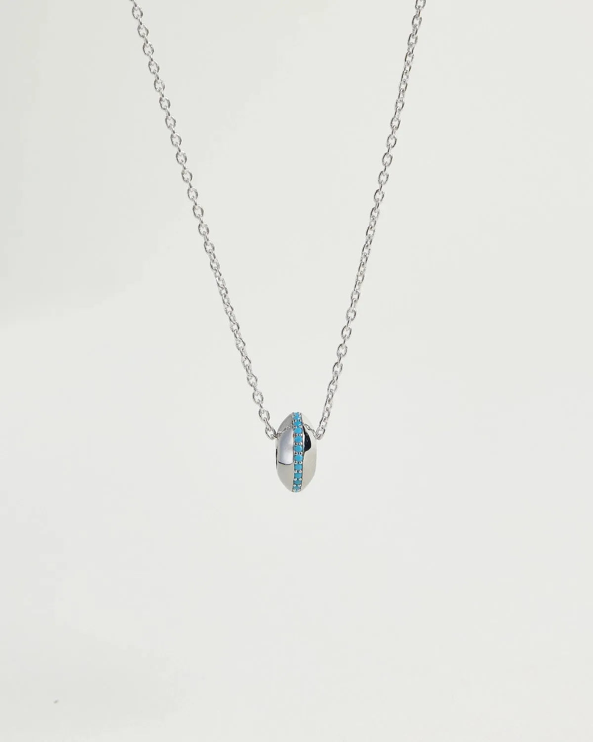 Mia silver necklace showing turquoise stone detail around the charm on a silver chain by MyAleph