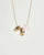 Noa gold necklace with rose quartz bead and diamond-detailed charms on a gold chain by MyAleph