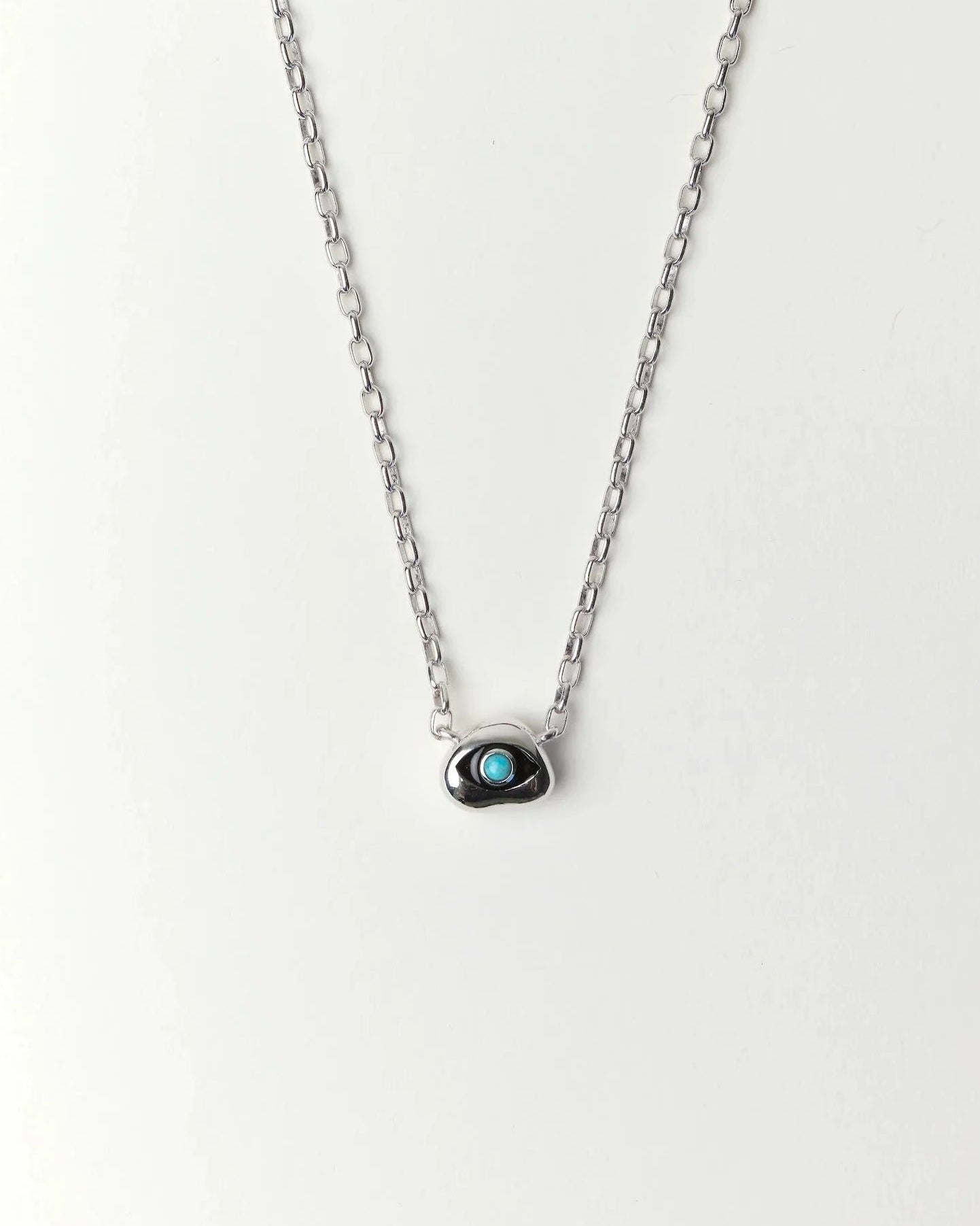 Aura Evil Eye necklace featuring a turquoise gemstone set in a silver tone pendant with premium rhodium plated hardware on a delicate chain.