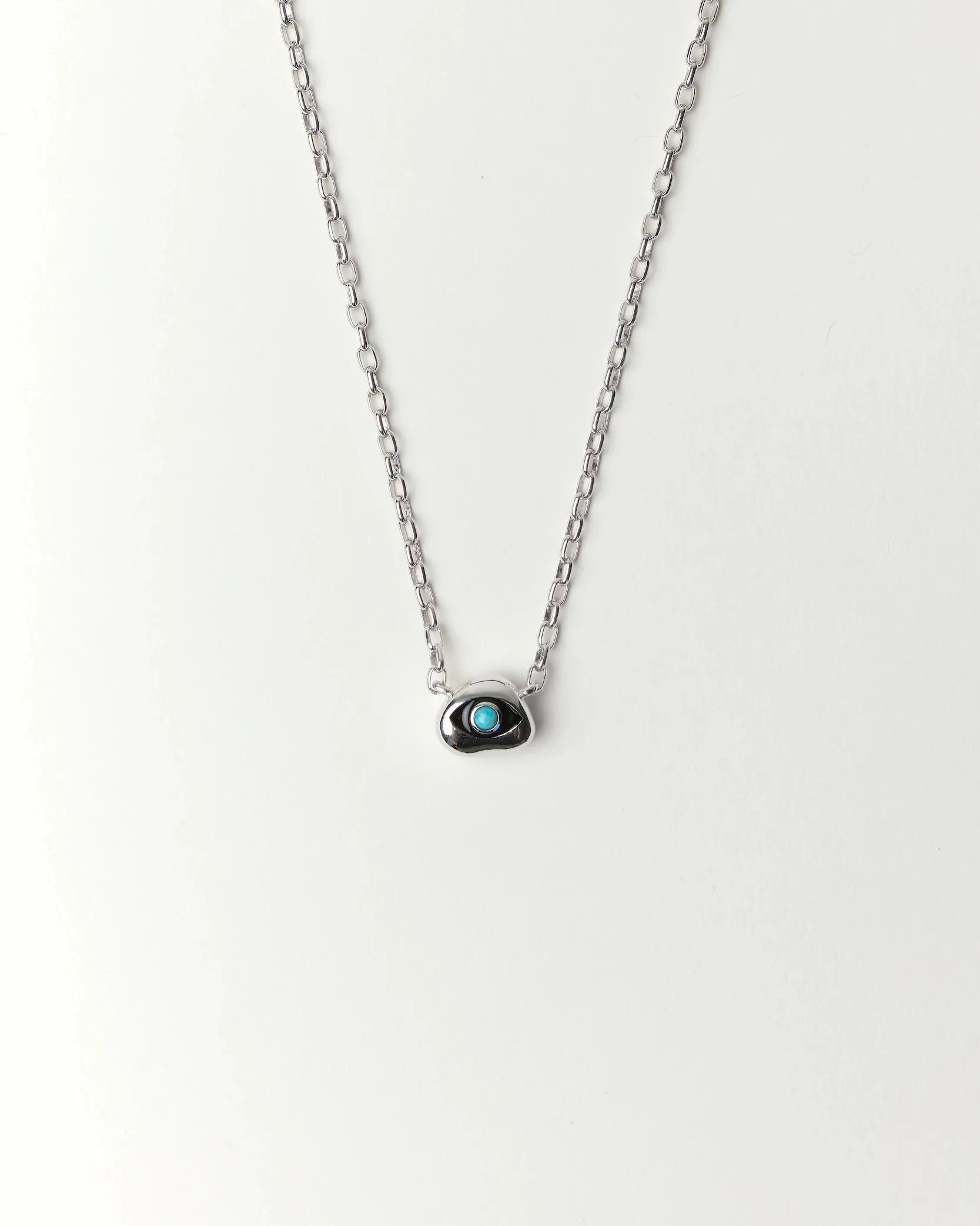 Aura Evil Eye necklace featuring a turquoise gemstone set in a silver tone pendant with premium rhodium plated hardware on a delicate chain.