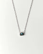 Aura Evil Eye necklace featuring a turquoise gemstone set in a silver tone pendant with premium rhodium plated hardware on a delicate chain.