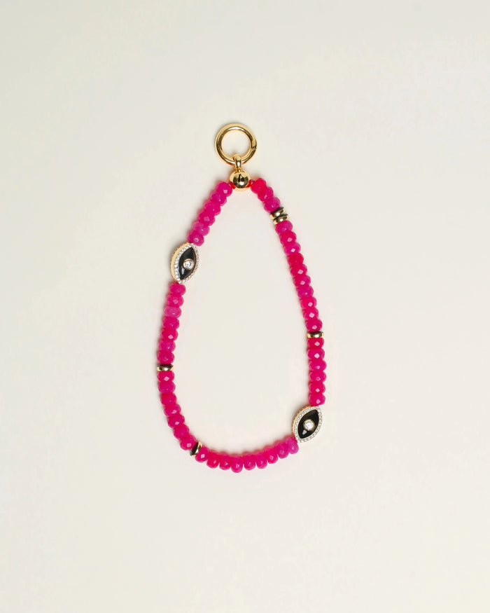 Close-up of Stella Bag Charm in Pink – A luxurious bag charm featuring vibrant pink quartz beads, 14k gold-plated charms, and a zirconia diamond Evil Eye charm for a bold, elegant look.