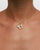 Model wearing MyAleph Chai Necklace, gold Hebrew life symbol pendant with white stone on delicate chain