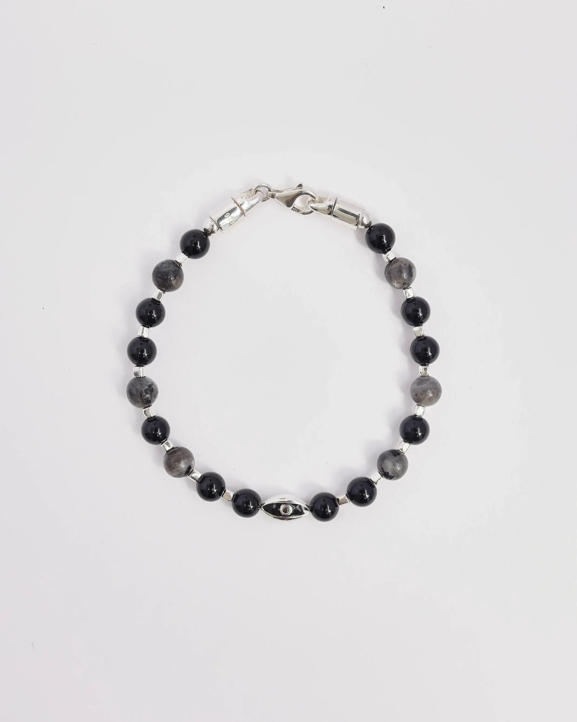 The David Bracelet in Silver laid flat, showcasing its polished silver finish, black onyx beads, and a single evil eye charm with a black CZ diamond.