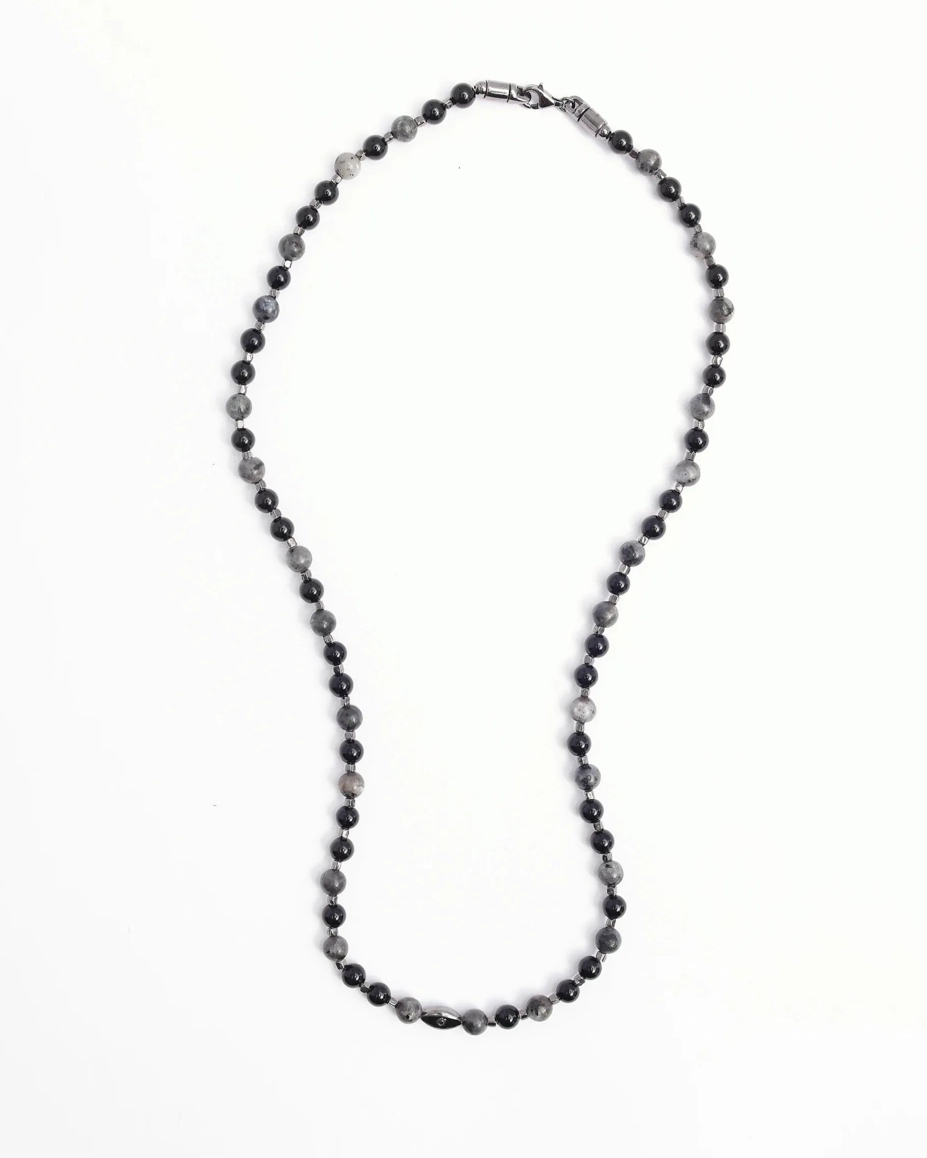 The David Wrap in Black Rhodium laid flat in a single strand, emphasizing the length and dual evil eye charms with black CZ diamonds.