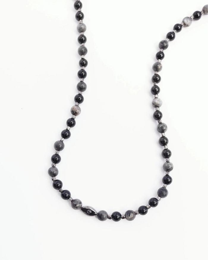 A close-up shot of the David Wrap in Black Rhodium, showing the intricate beadwork and dual evil eye charms with black CZ diamonds against a neutral background.