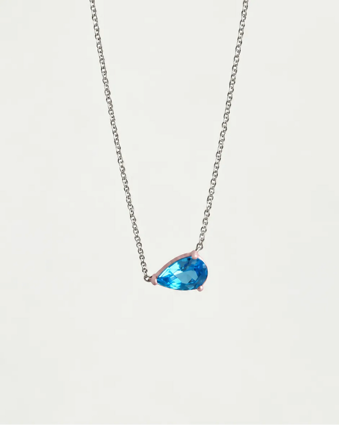 Eden Necklace with a pear cut Blue Topaz Gemstone and baby pink enamel on a silver rhodium-plated chain