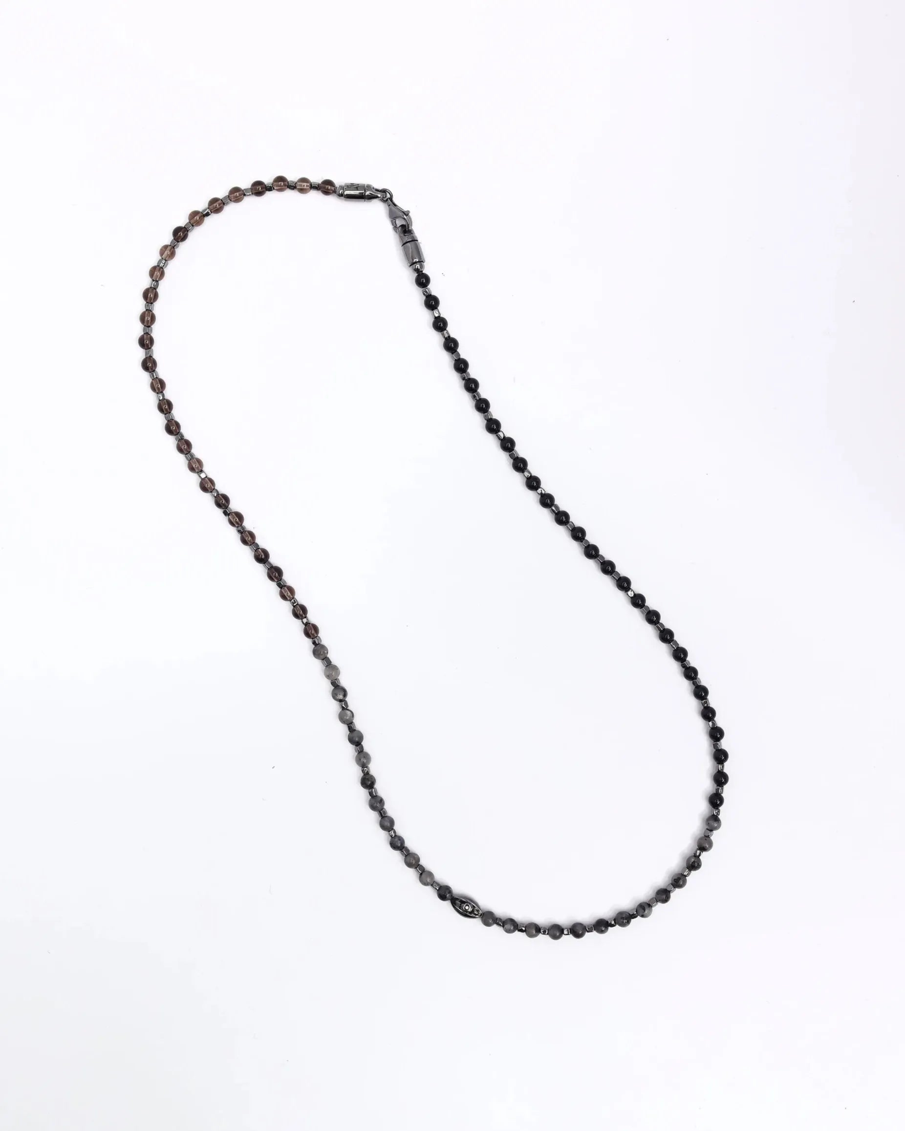 The Ethan Wrap in Silver laid flat in a single strand, highlighting the intricate beadwork, dual evil eye charms, and combination of onyx, labradorite, and smoky quartz.