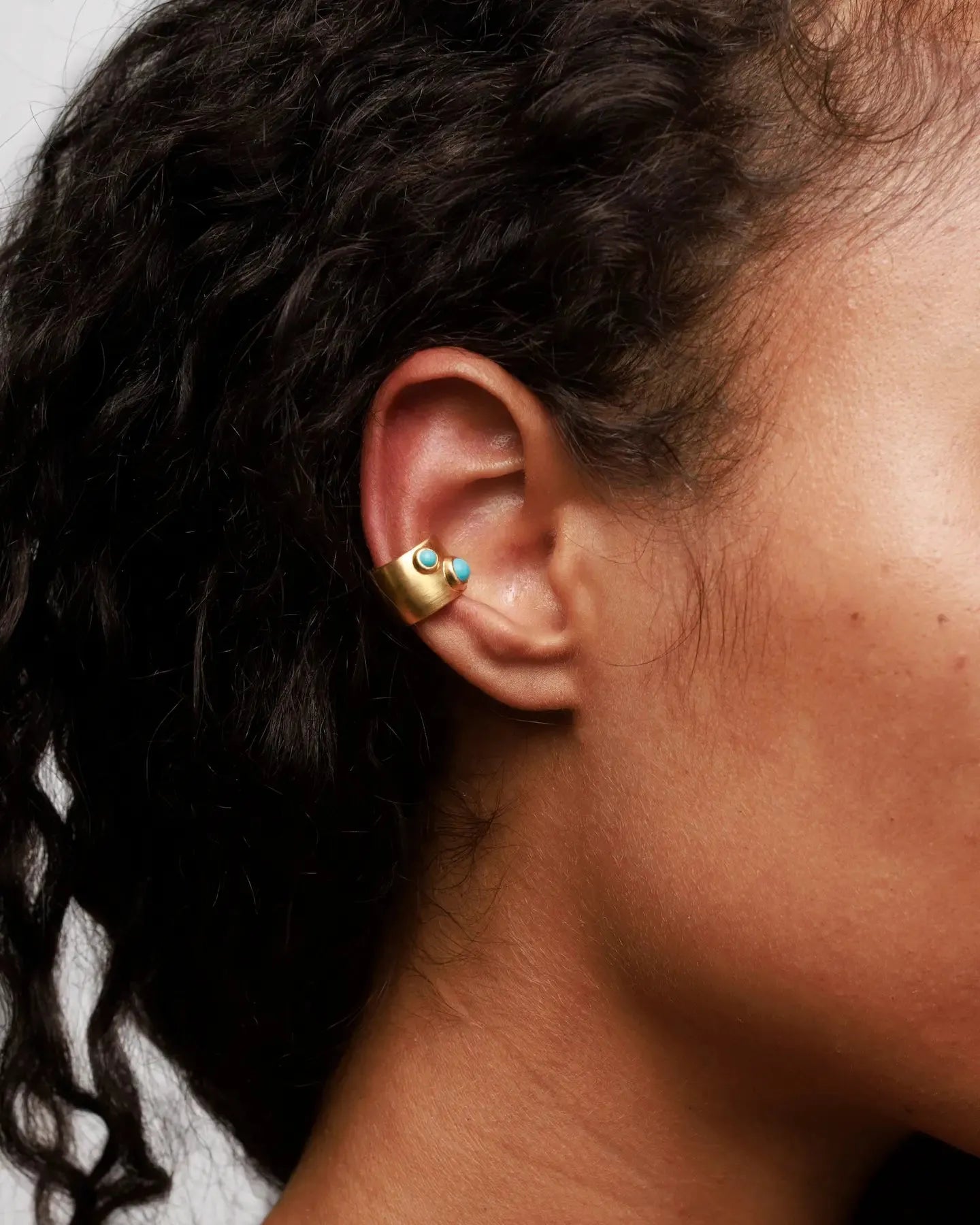 Model wearing MyAleph Galet Ear Cuff with turquoise stones, no-piercing ear cuff in gold vermeil