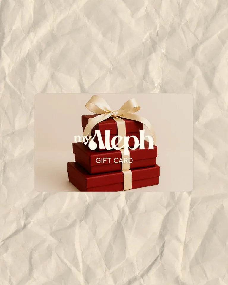 Red gift box with a gold bow on a textured beige background, featuring the Aleph brand.