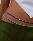 Model wearing Juliana Turquoise Belly Chain with Evil Eye Charm layered over green skirt.