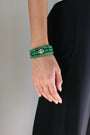 Stacked emerald quartz beaded bracelets with gold evil eye charm on wrist