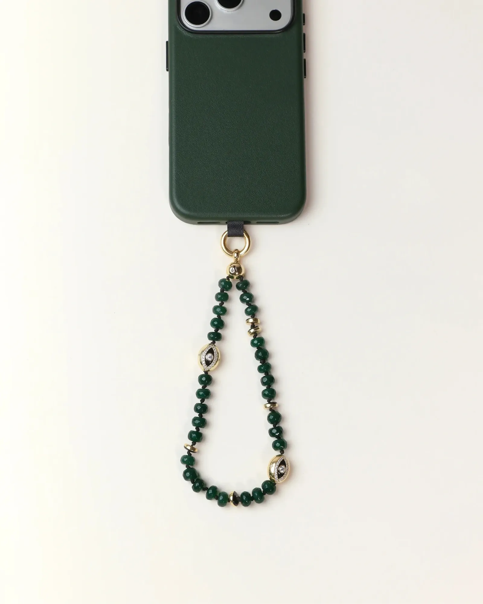 Emerald phone case with a beaded chain on a white background