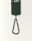 Emerald phone case with a beaded chain on a white background