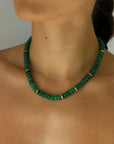 Emerald quartz beaded necklace with gold accents worn on neckline
