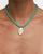 Model wearing MyAleph Lola Cord Necklace in Safran with turquoise cord and gold evil eye pendant