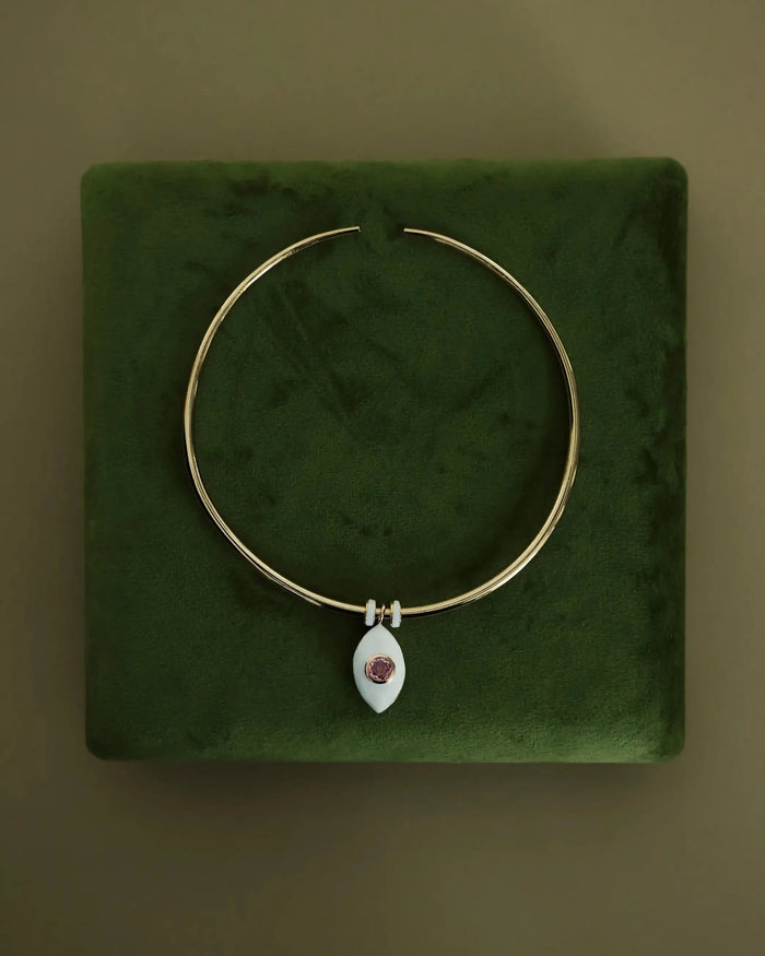 Necklace displayed on a green velvet jewelry pad, emphasizing its soft, romantic tones and luxe finish.