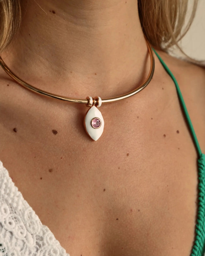 Close-up of the necklace worn with a green strap bikini top, highlighting the pink charm centered at the collarbone.