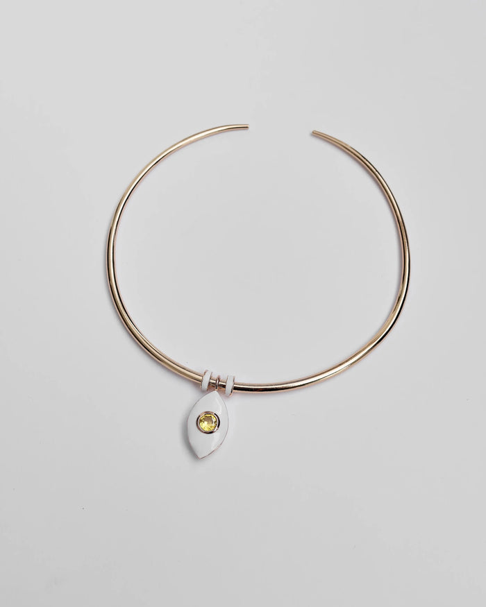 Overhead image of the necklace laid flat, highlighting the yellow CZ crystal and gold-accented dividers.