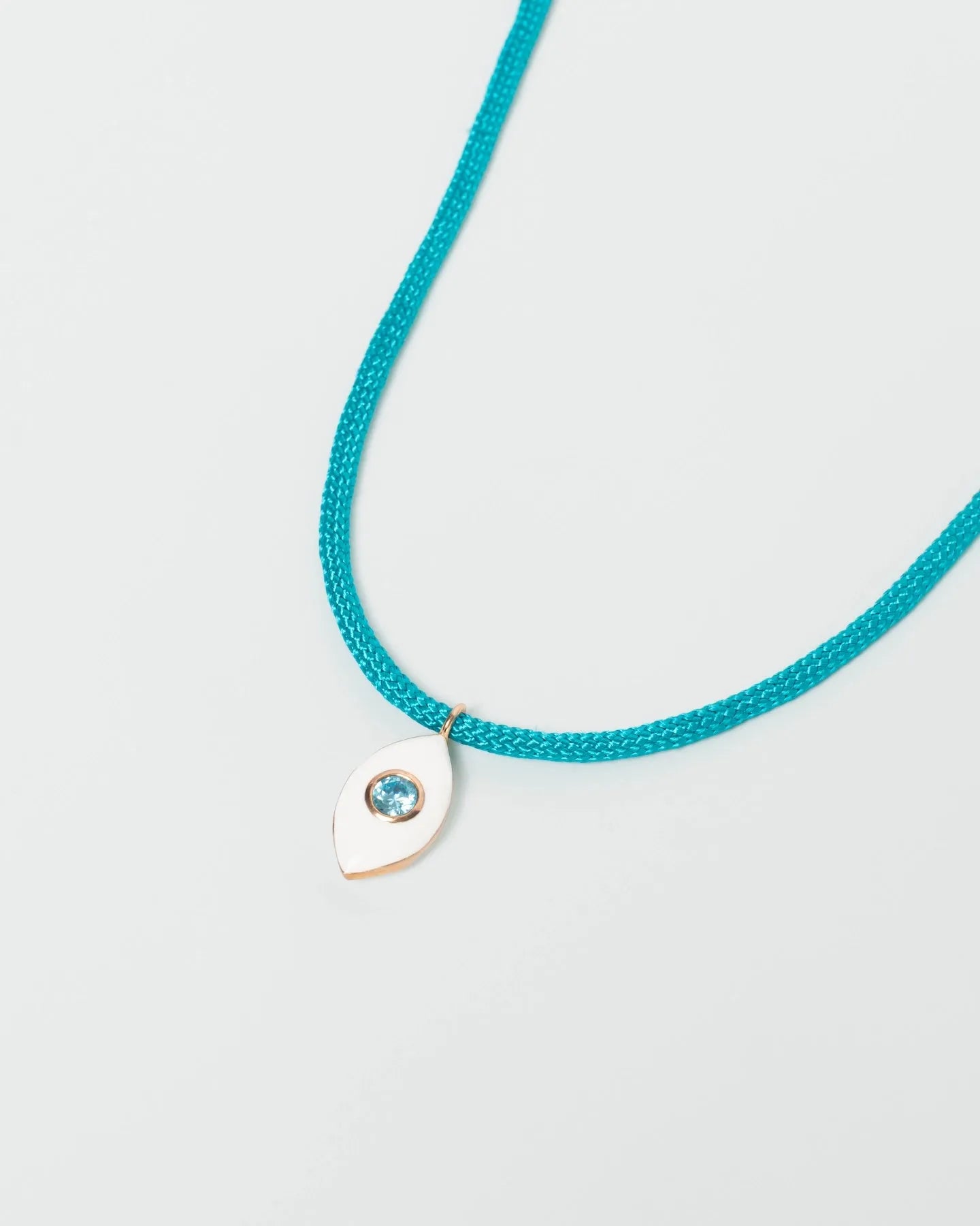 MyAleph Lola Cord Necklace with turquoise blue cord, gold evil eye pendant, and white background