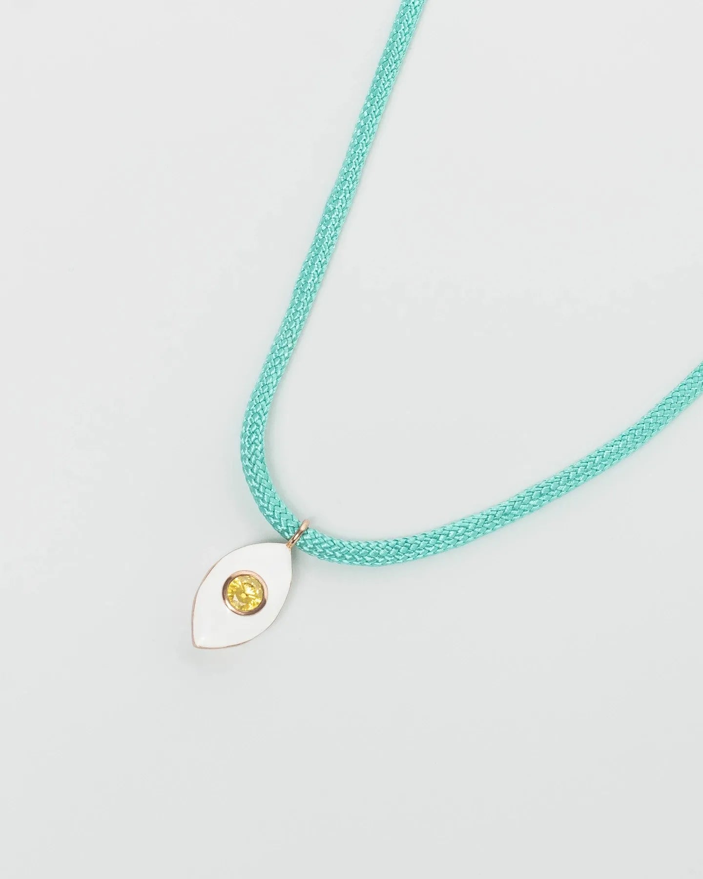 MyAleph Lola Cord Necklace in Safran with turquoise cord, gold evil eye pendant, and white background