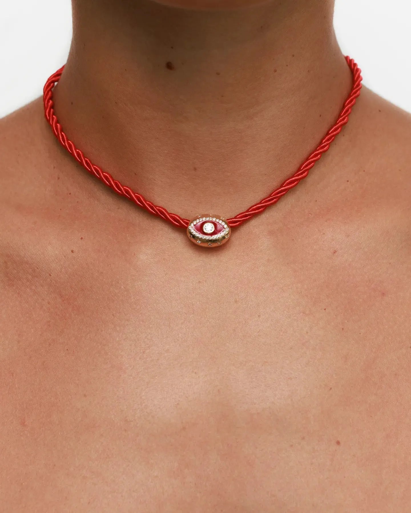 Model wearing MyAleph Luna Cord Necklace with red silk cord and gold evil eye pendant