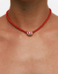 Model wearing MyAleph Luna Cord Necklace with red silk cord and gold evil eye pendant