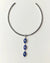 Silver necklace with blue evil eye pendant on a white background
