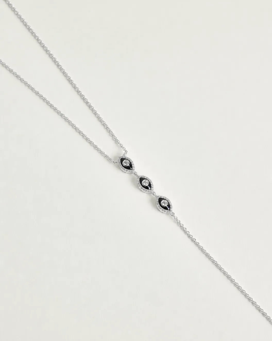 Mayra Evil Eye Body Chain in silver dipped full length view from neck chain to waist chain extension on white surface