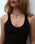 Model wearing the necklace styled with a scoop neckline, emphasizing the elegant drape and statement look.