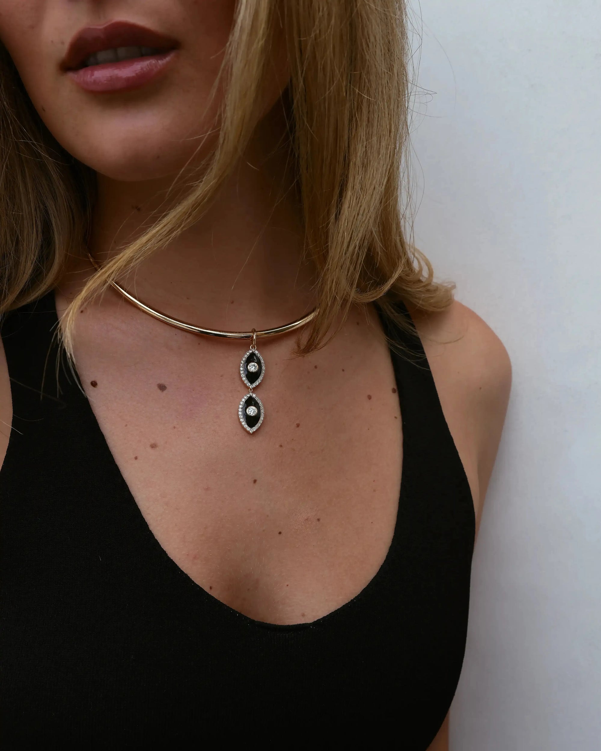 Model wearing the Mayra Collar Necklace – Charm Pair with a black tank top, showing the necklace's drop design.