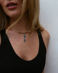 Model wearing the Mayra Collar Necklace – Charm Pair with a black tank top, showing the necklace's drop design.