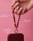 Mini Leah Ruby Quartz Phone Charm showing evil eye protection and tarnish-free 14k gold hardware.