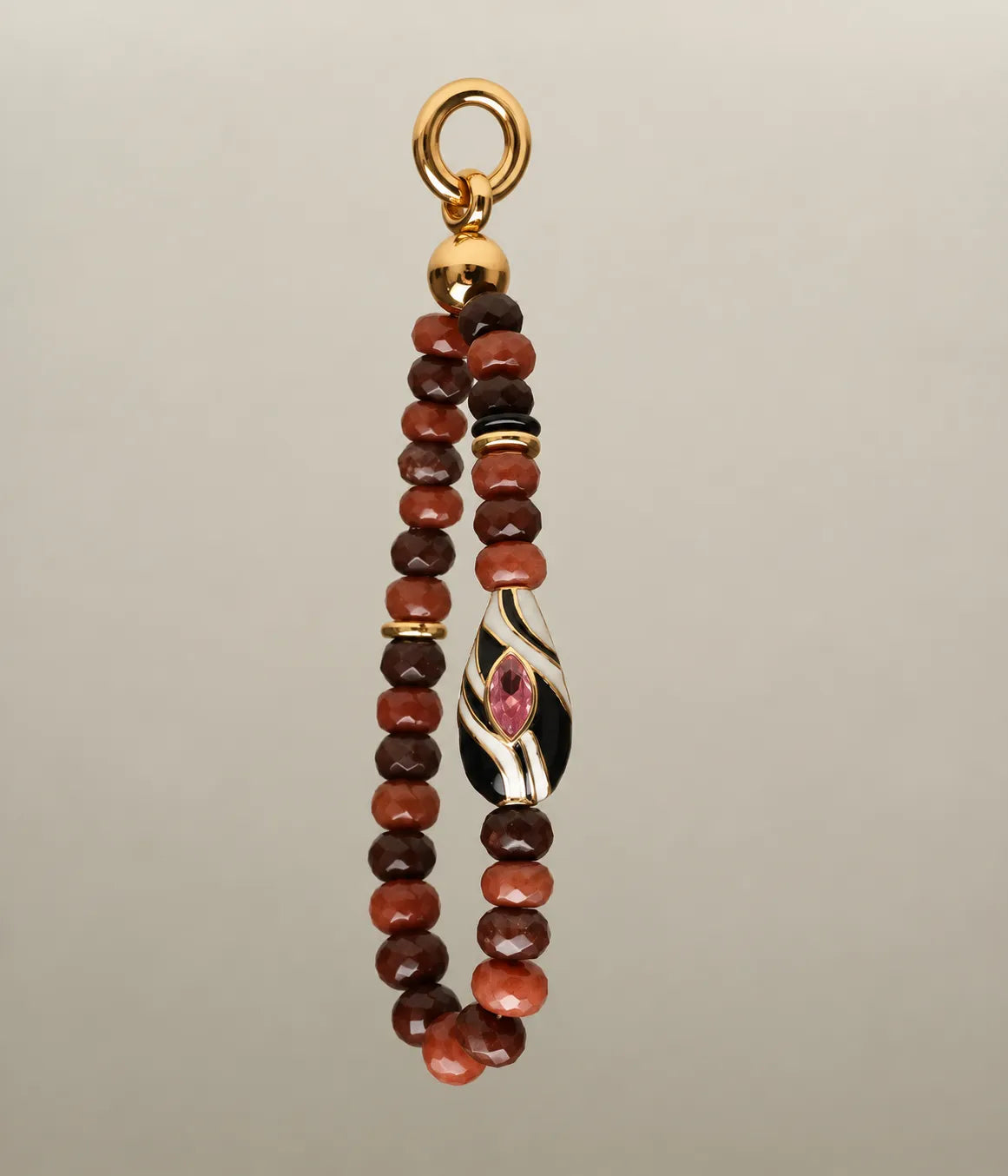 Mini Minou Bag Charm in Espresso featuring faceted brown quartz beads, gold spacers, and a black and white zebra evil eye charm with pink gemstone detail.