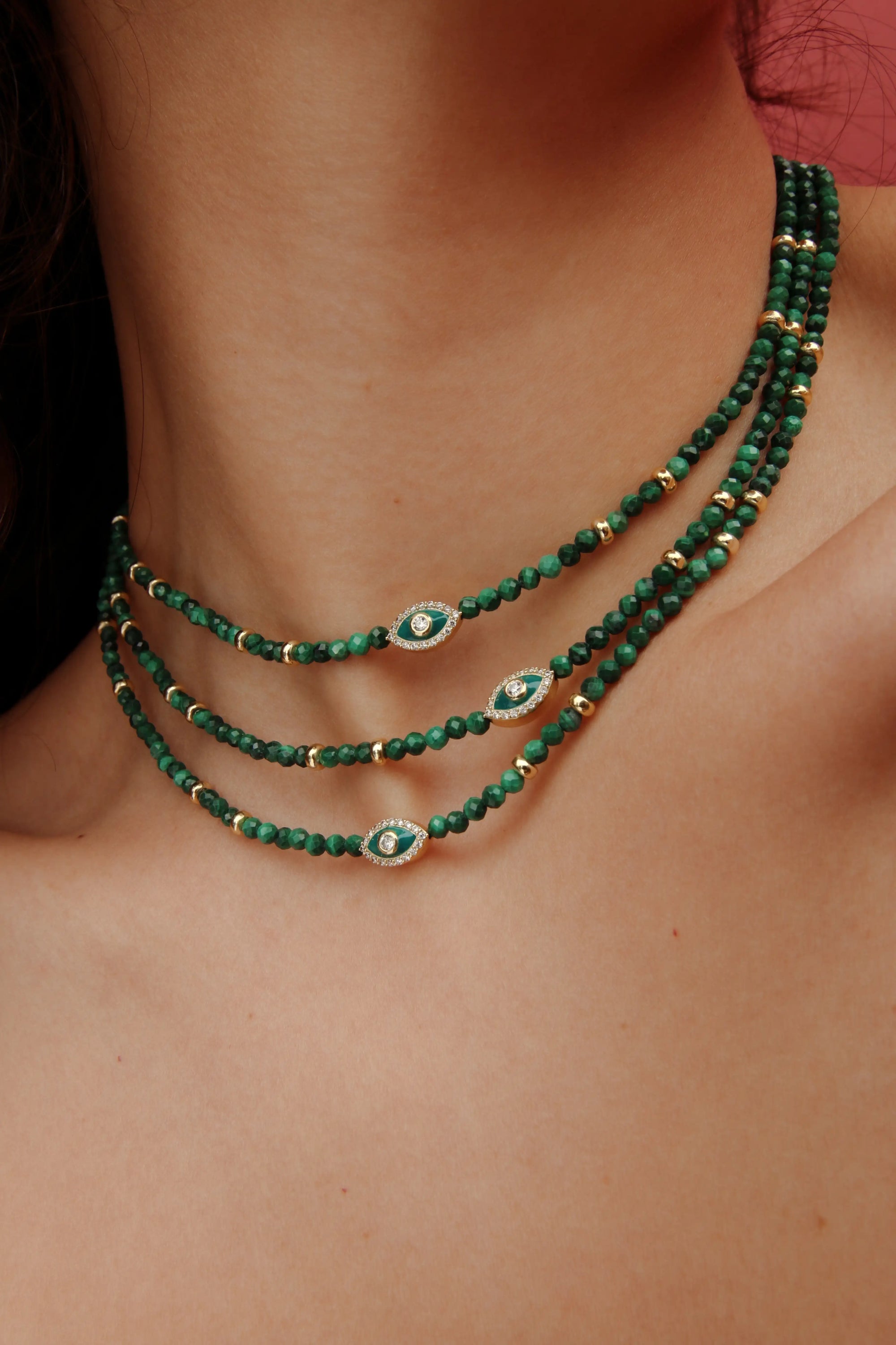 Styled shot of the Juliana necklace in malachite, worn as a statement piece.